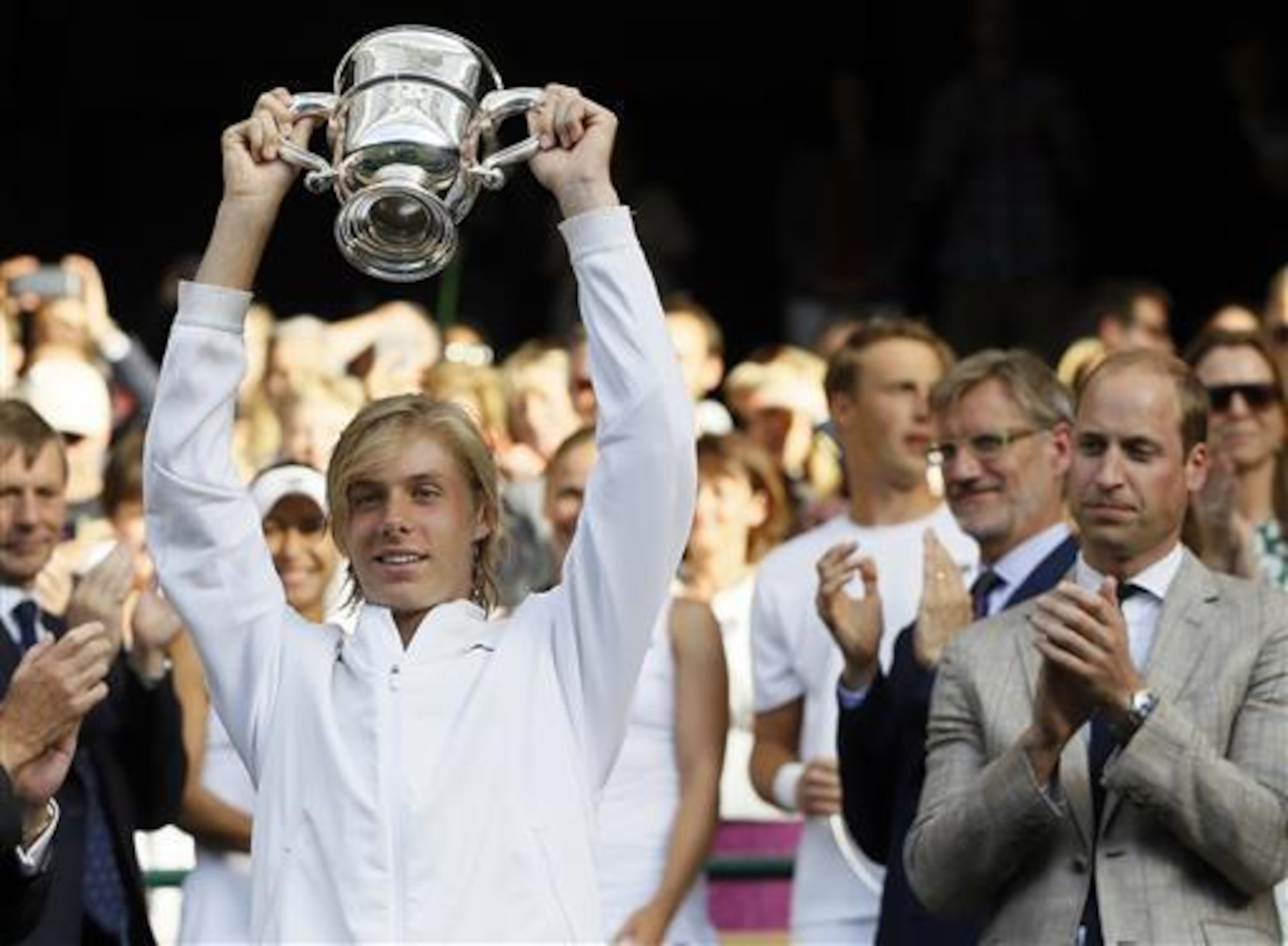 Denis Shapovalov shows off the trophy after winning the 2016 Wimbledon juniors title.