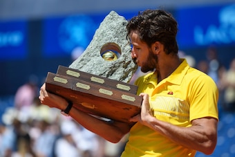 Feliciano Lopez kisses the stone-like trophy after winning the 2016 Swiss Open.