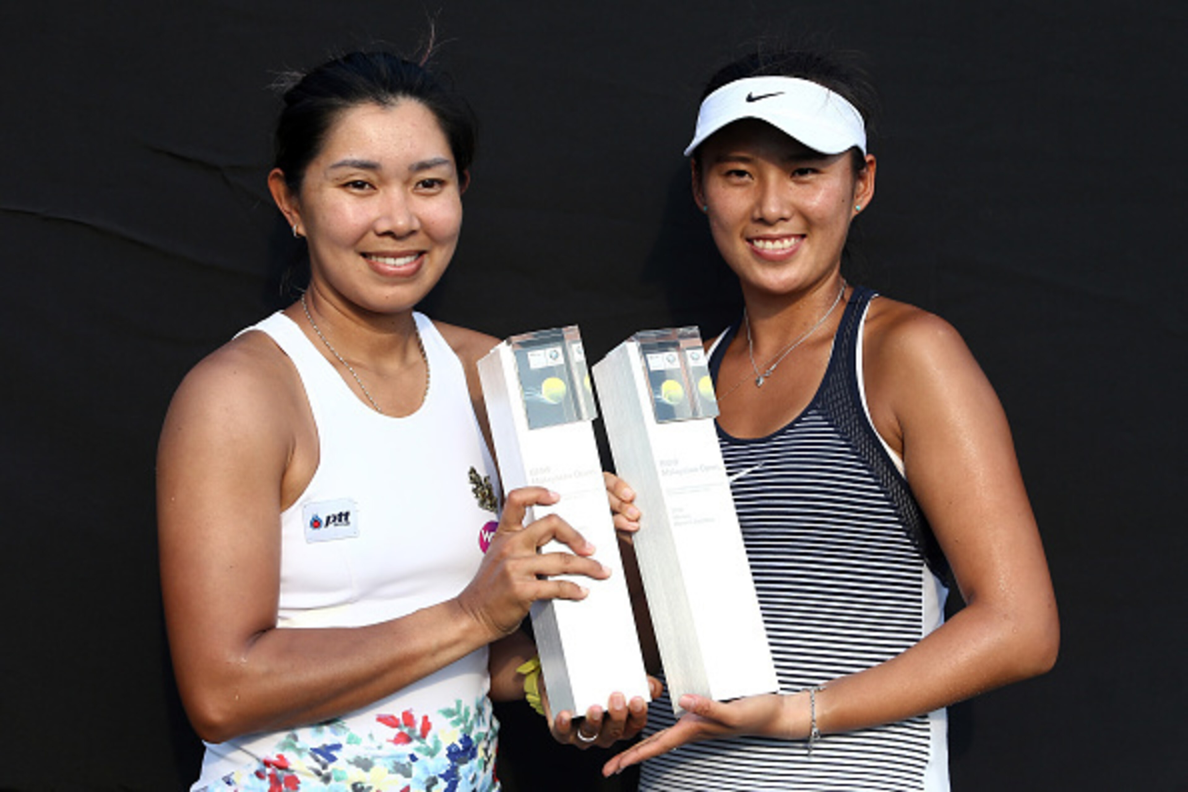 KUALA LUMPUR, MALAYSIA - MARCH 06: Varatchata Wongteanchai (L) of Thailand and Zhaoxuan Yang of China pose with the BMW Malaysian Open Doubles Champion Trophy after the Doubles Final of the 2016 BMW Malaysian Open at Kuala Lumpur Golf & Country Club on M KUALA LUMPUR, MALAYSIA - MARCH 06: Varatchata Wongteanchai (L) of Thailand and Zhaoxuan Yang of China pose with the BMW Malaysian Open Doubles Champion Trophy after the Doubles Final of the 2016 BMW Malaysian Open at Kuala Lumpur Golf & Country Club on M