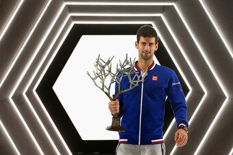 Novak Djokovic holds the trophy from the 2015 Paris Masters.