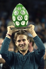 Lucas Pouille shows off his trophy after winning the Moselle Open in Metz, France.