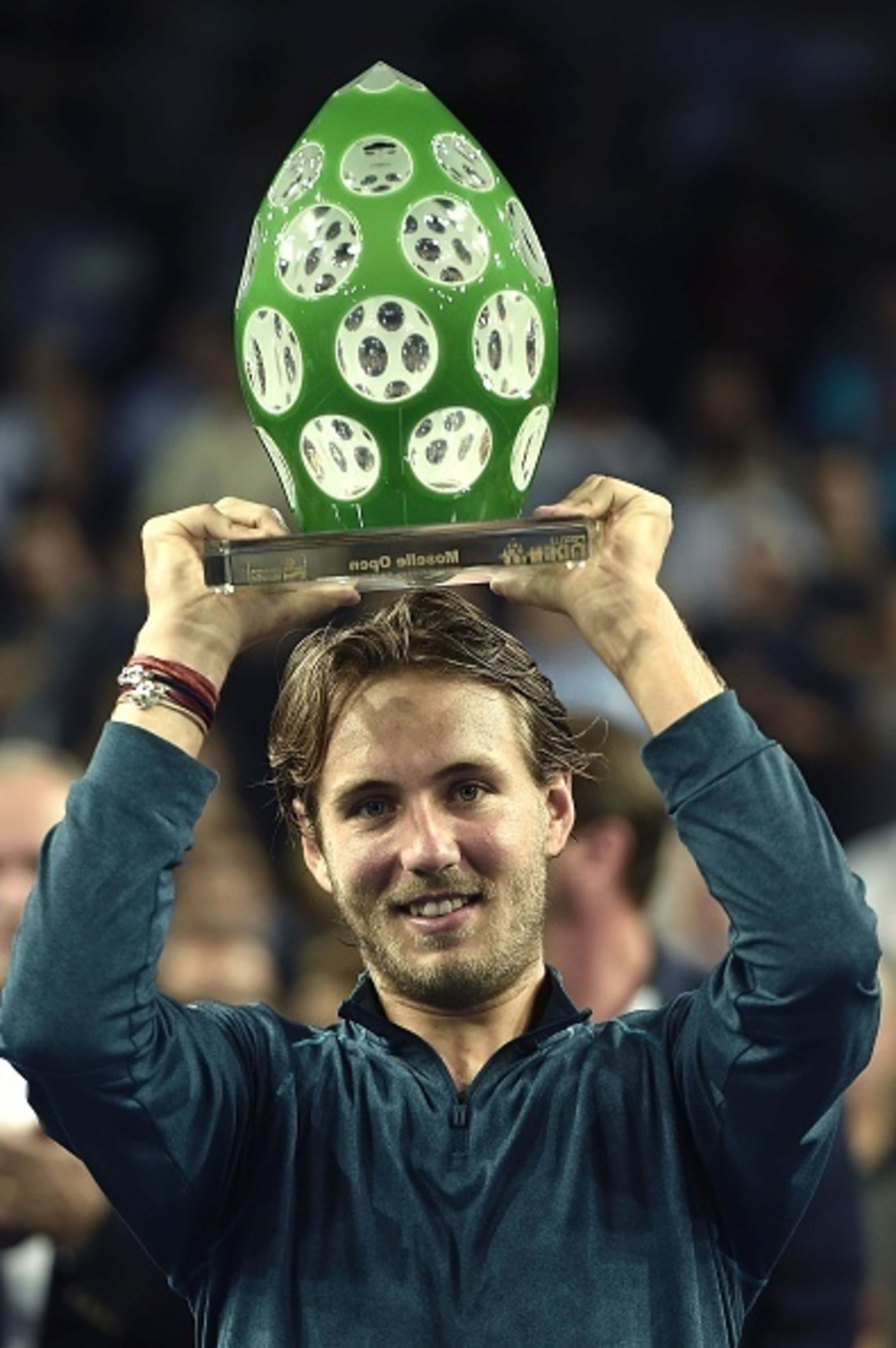 Lucas Pouille shows off his trophy after winning the Moselle Open in Metz, France. Lucas Pouille shows off his trophy after winning the Moselle Open in Metz, France.