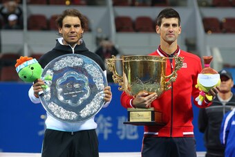 Rafael Nadal and Novak Djokovic pose during the trophy presentation at the 2015 China Open in Beijing.