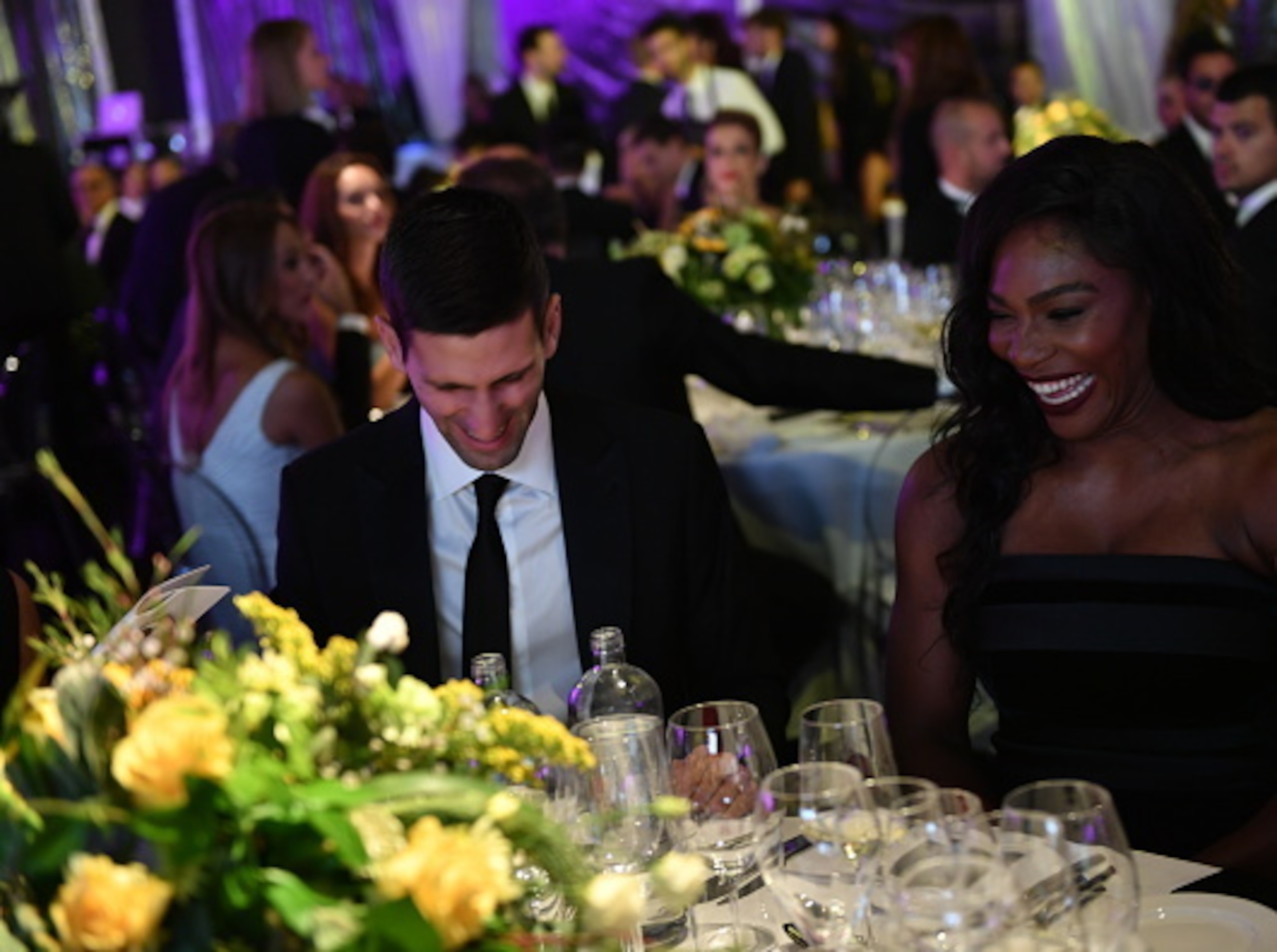 Novak Djokovic and Serena Williams joke at a benefit in Milan.