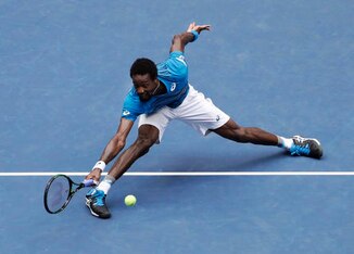 Gael Monfils slides to make a play on the ball during the 2016 U.S. Open.