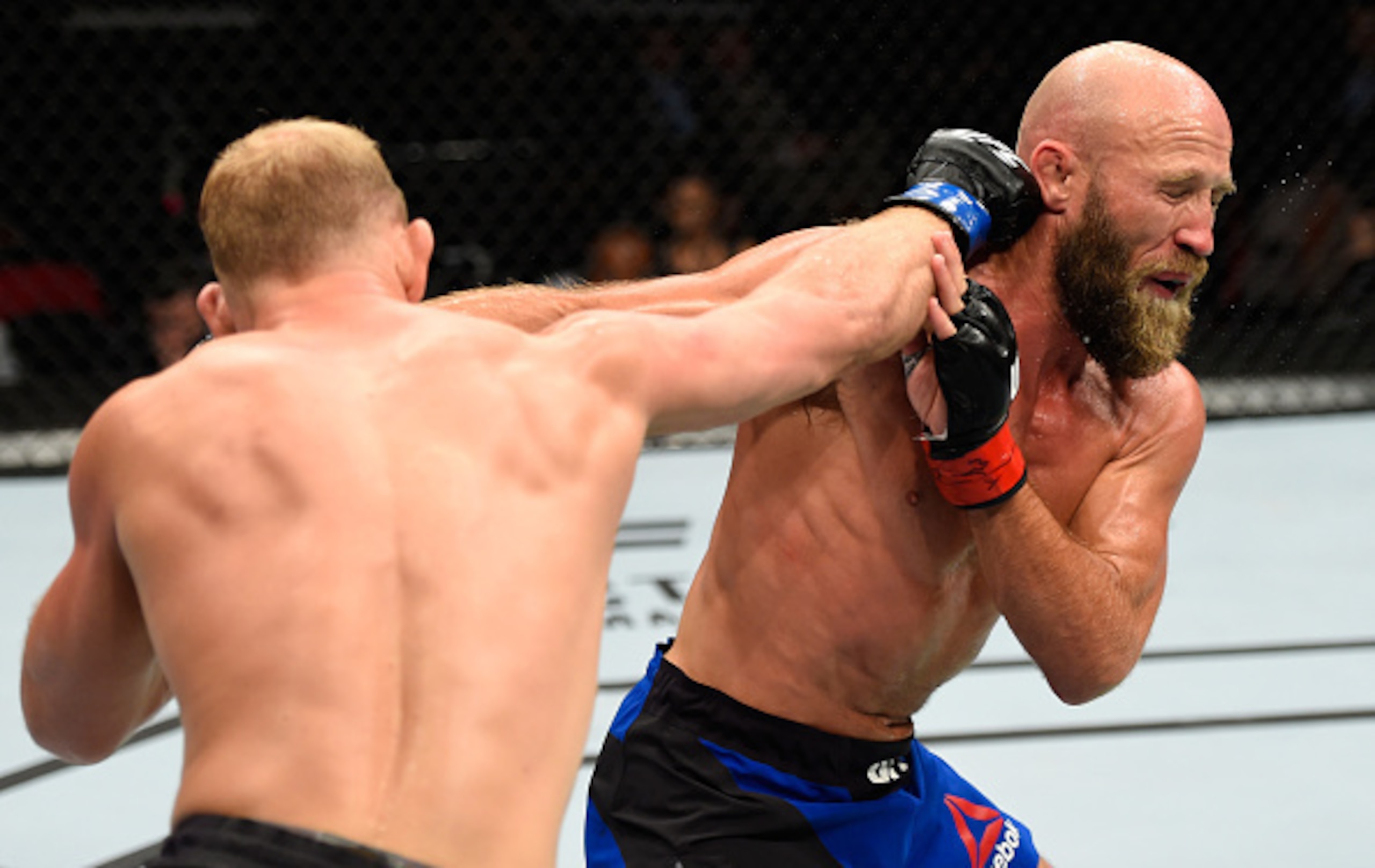 Joshua Burkman (right) takes a punch from Zak Ottow. Joshua Burkman (right) takes a punch from Zak Ottow.