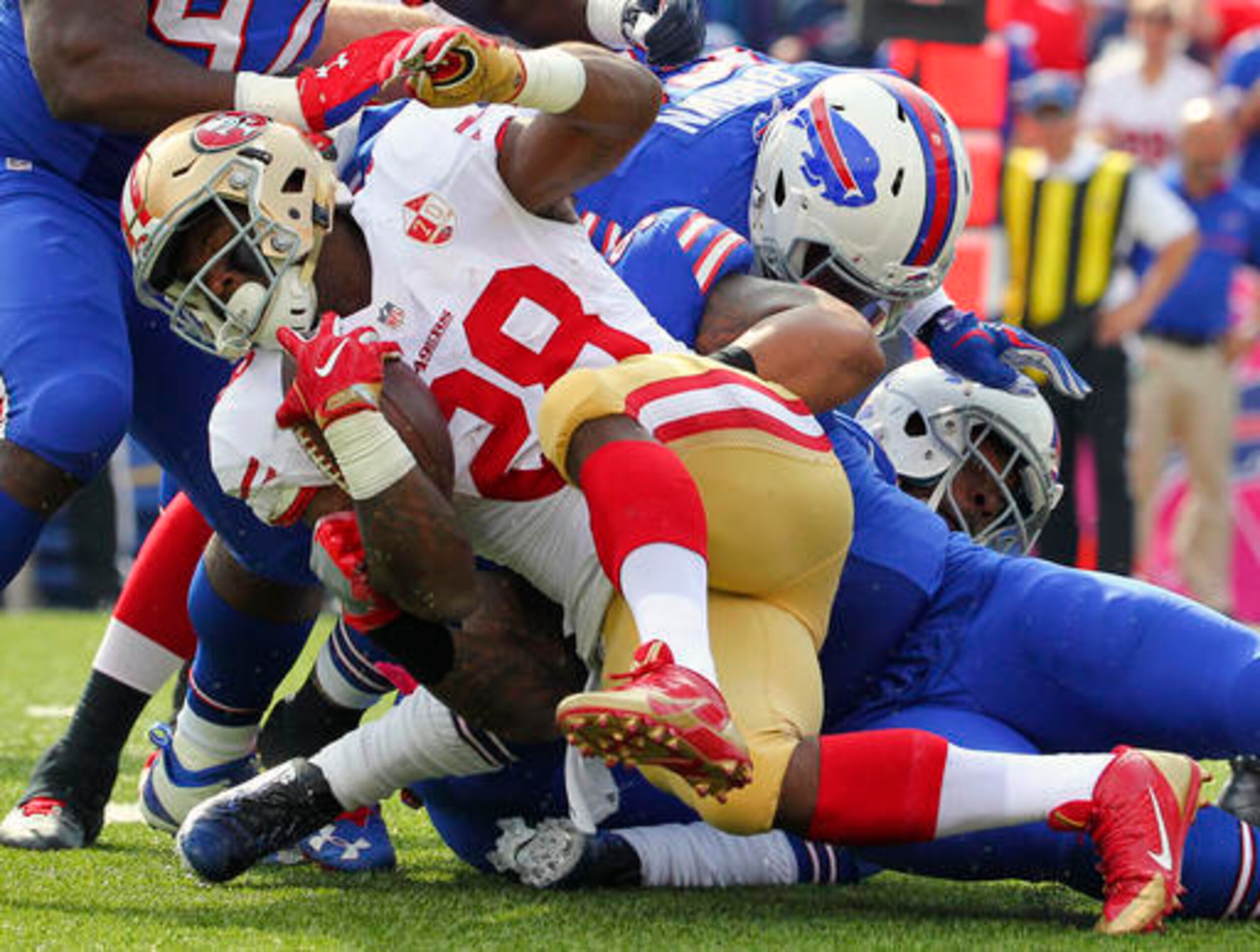 San Francisco 49ers running back Carlos Hyde (28) is tackled by Buffalo Bills defenders during the first half of an NFL football game on Sunday, Oct. 16, 2016, in Orchard Park, N.Y. (AP Photo/Bill Wippert)