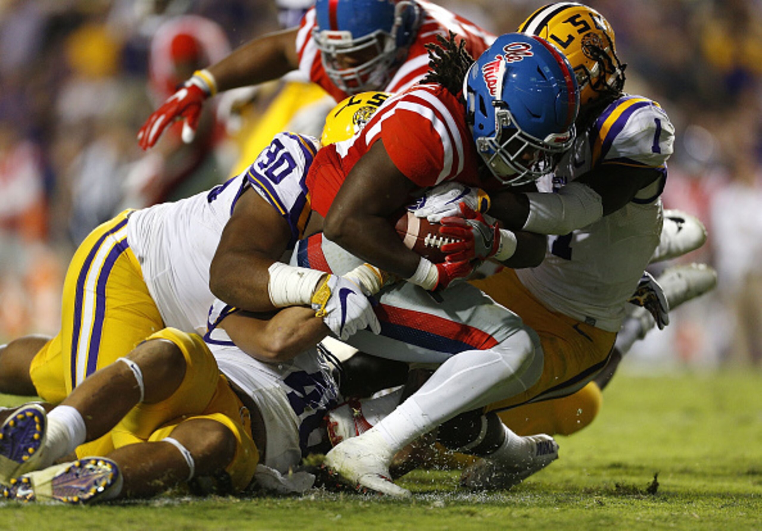 BATON ROUGE, LA - OCTOBER 22: Eugene Brazley #23 of the Mississippi Rebels is tackled by Donte Jackson #1 of the LSU Tigers, Rashard Lawrence #90 and Duke Riley #40 during the second half of a game at Tiger Stadium on October 22, 2016 in Baton Rouge, Loui