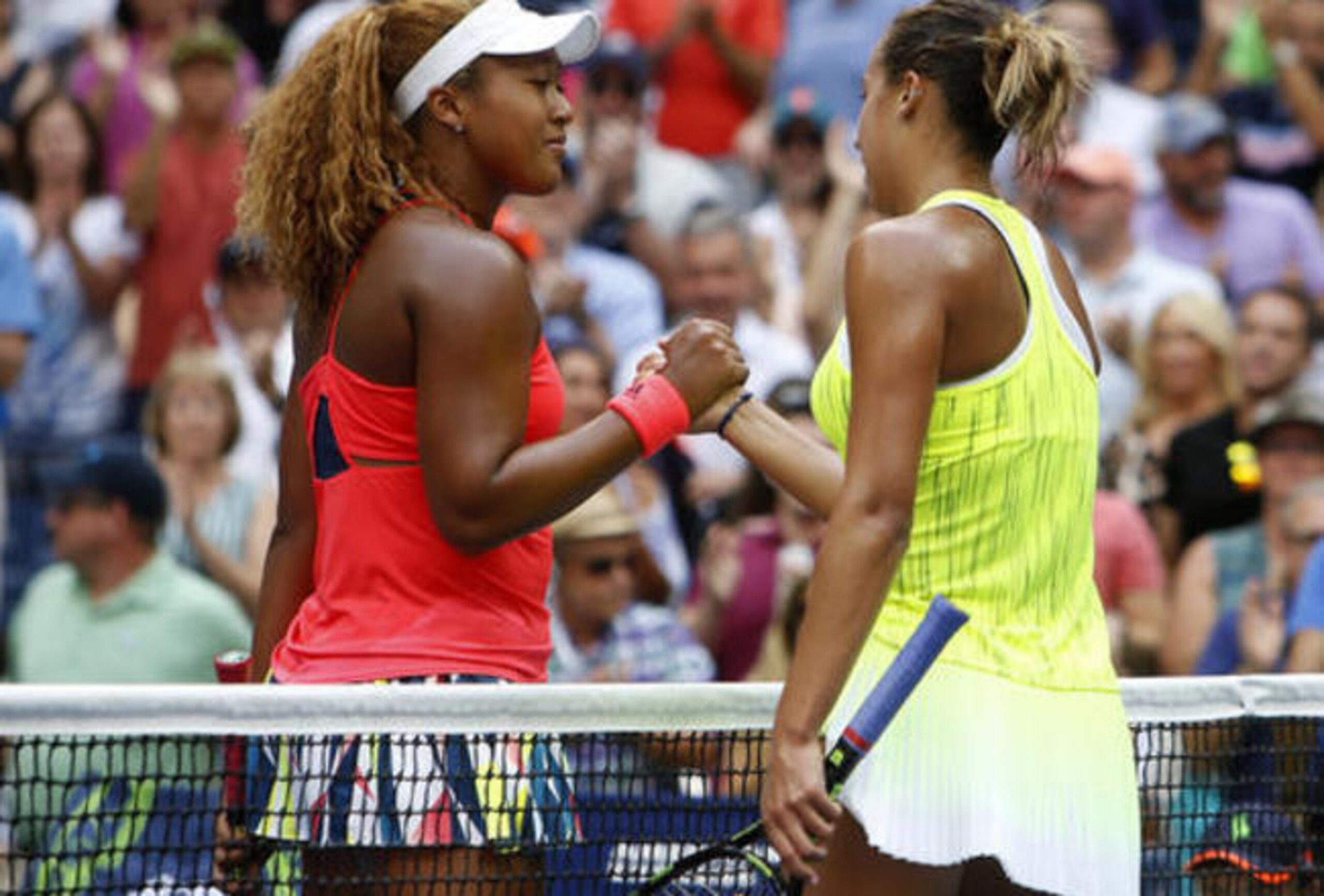 Naomi Osaka, left, and Madison Keys shake hands after a match at the 2016 U.S. Open