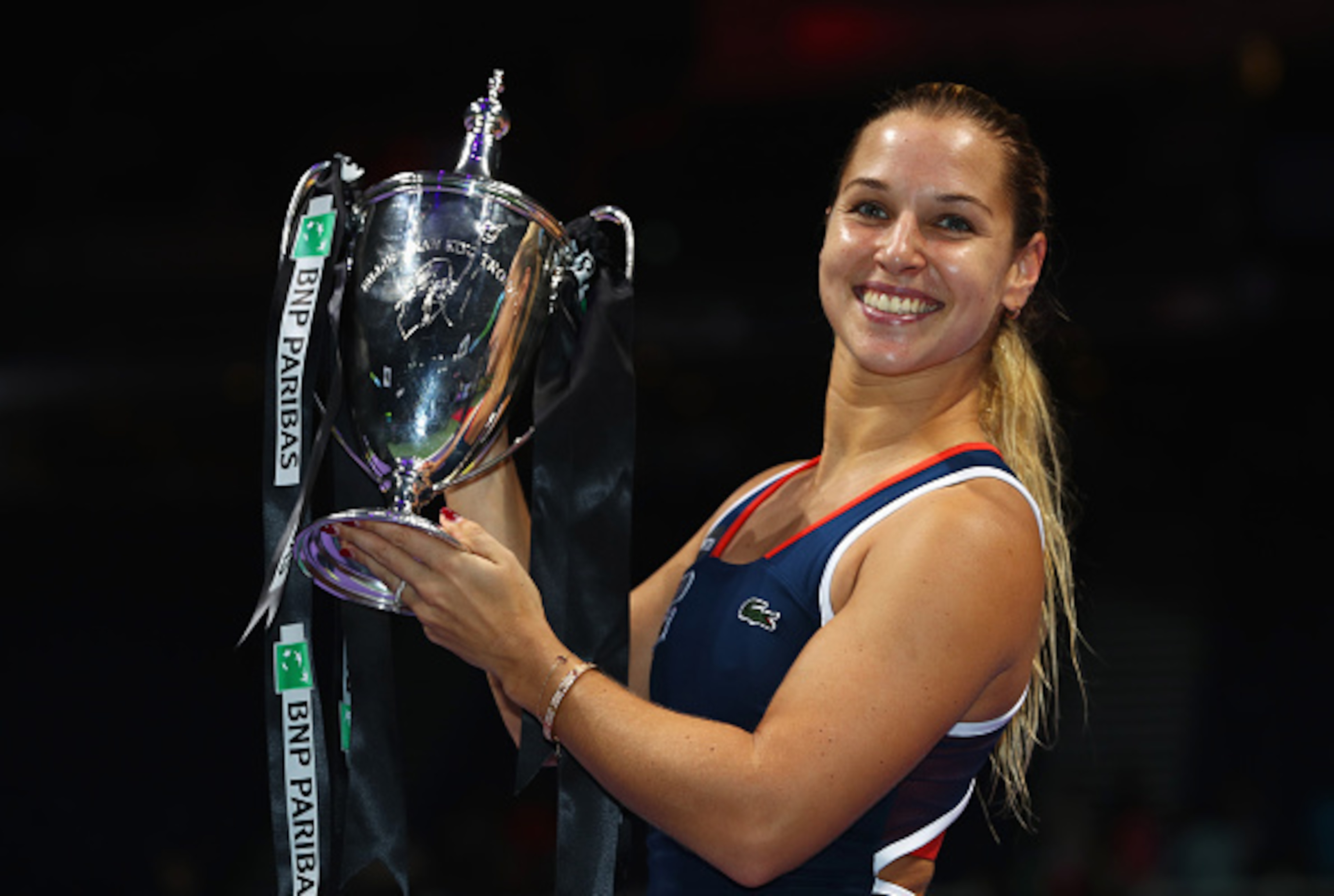 Dominika Cibulkova shows off the trophy she won at the 2016 WTA Tour Finals in Singapore.
