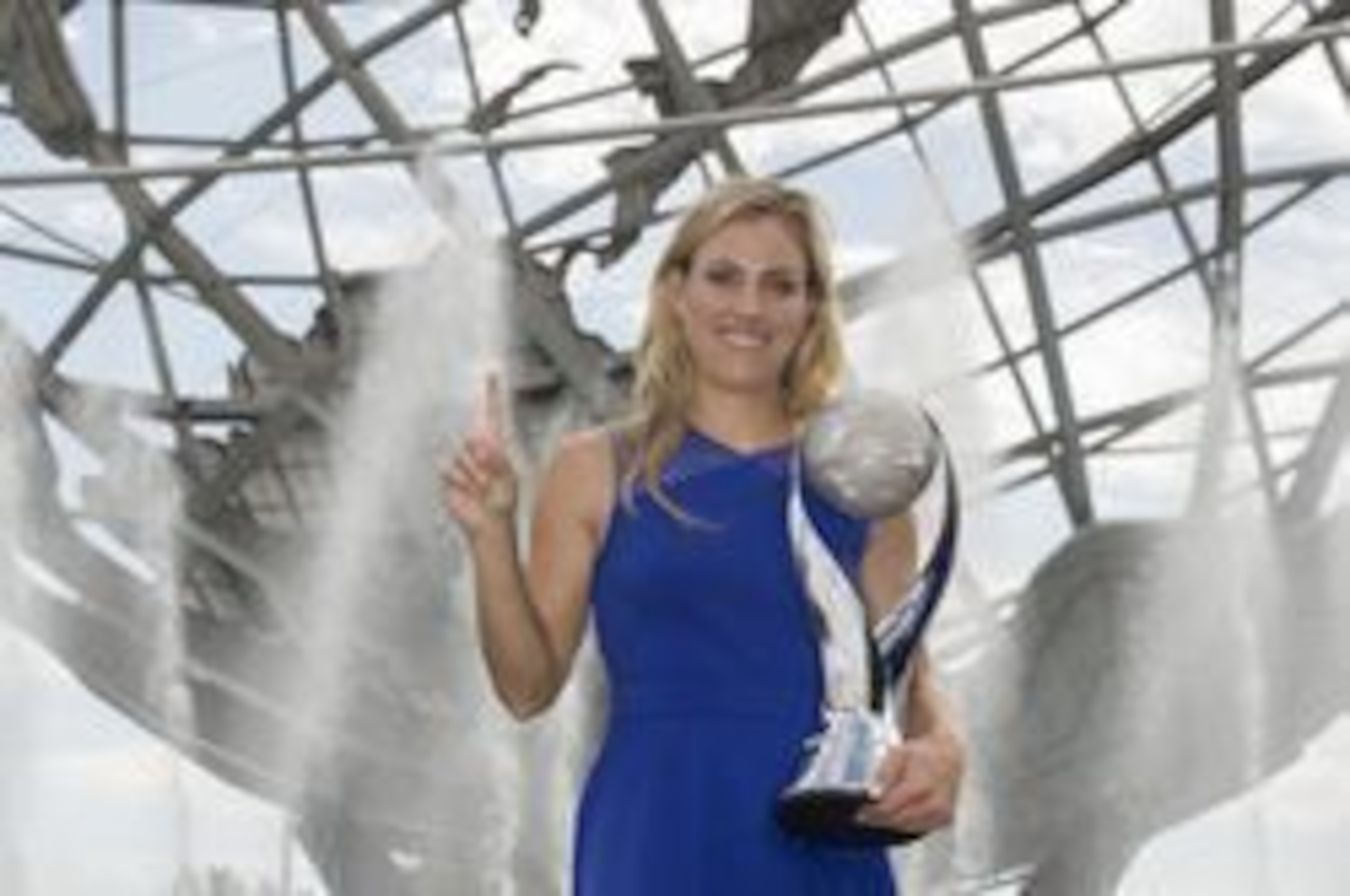 Angelique Kerber holds up the No. 1 sign as she shows off the trophy given to the WTA Tour's new No. 1 player at Flushing Meadows, NY.