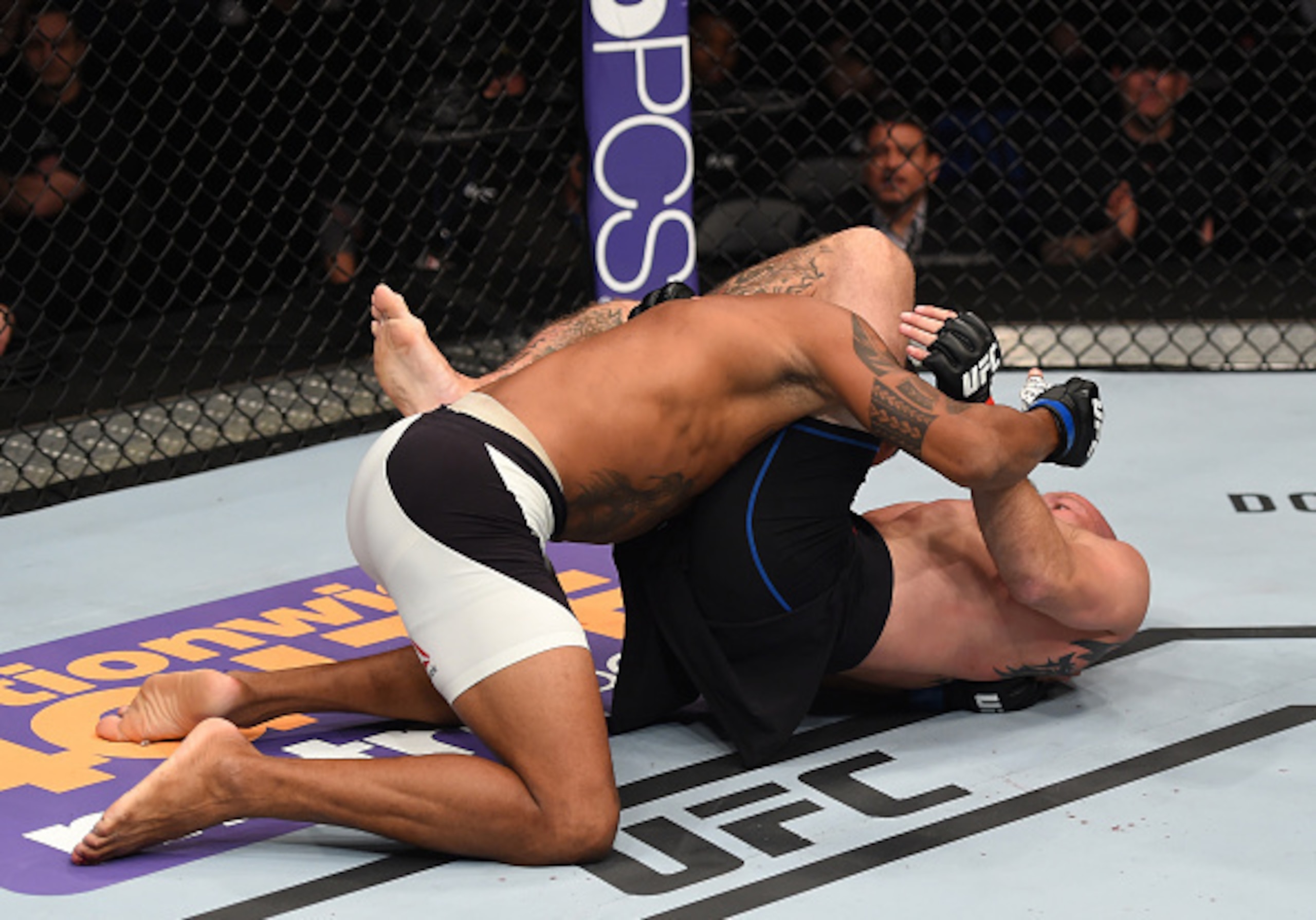 Pictured: Cowboy submitting Cowboy with a triangle choke.