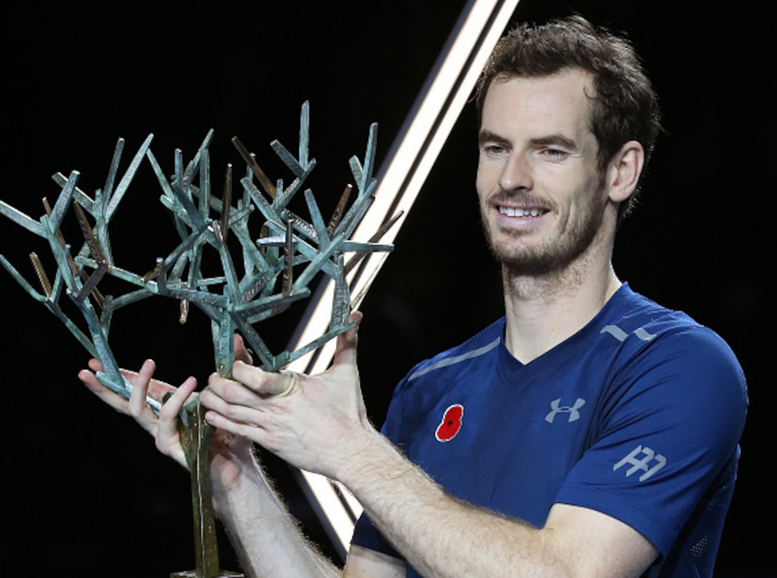 Andy Murray shows off the trophy he won at the 2016 Paris Masters.