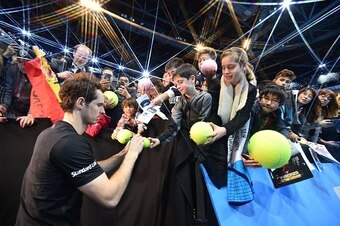 Andy Murray signs autographs after winning his semifinals match at the 2016 ATP World Tour Finals in London.