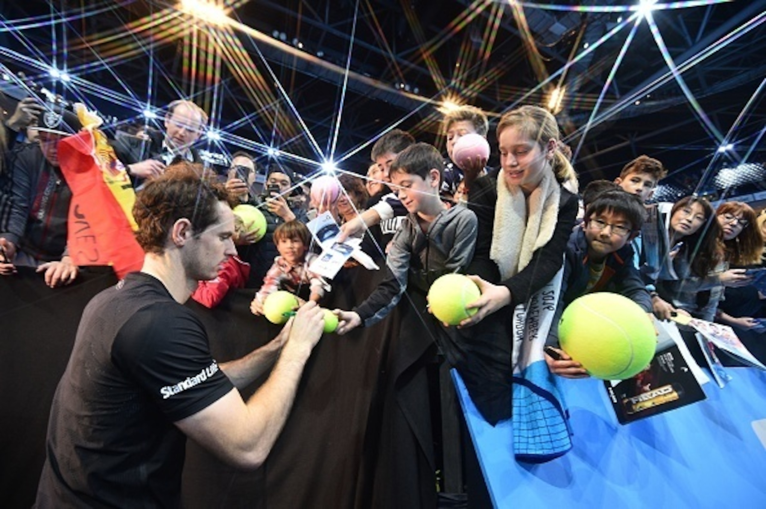 Andy Murray signs autographs after winning his semifinals match at the 2016 ATP World Tour Finals in London.
