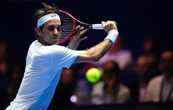 Roger Federer hits a backhand during a 2015 IPTL event.