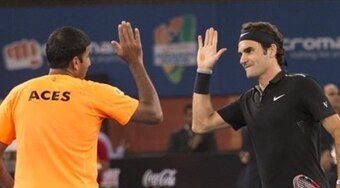 Rohan Bopanna high-fives Roger Federer during an IPTL match for the Indian Aces.