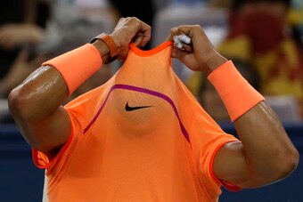 Rafael Nadal pulls his shirt over his head during a match at the 2016 Shanghai Masters.