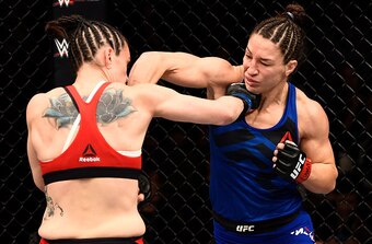 Alexis Davis (left) punches Sara McMann