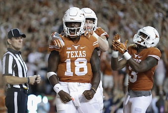 AUSTIN, TX - SEPTEMBER 04:  Tyrone Swoopes #18 of the Texas Longhorns celebrates with teammates after scoring a touchdown in the first overtime against the Notre Dame Fighting Irish at Darrell K. Royal-Texas Memorial Stadium on September 4, 2016 in Austin