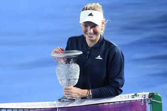 Caroline Wozniacki shows off the trophy after winning a tournament in Hong Kong.