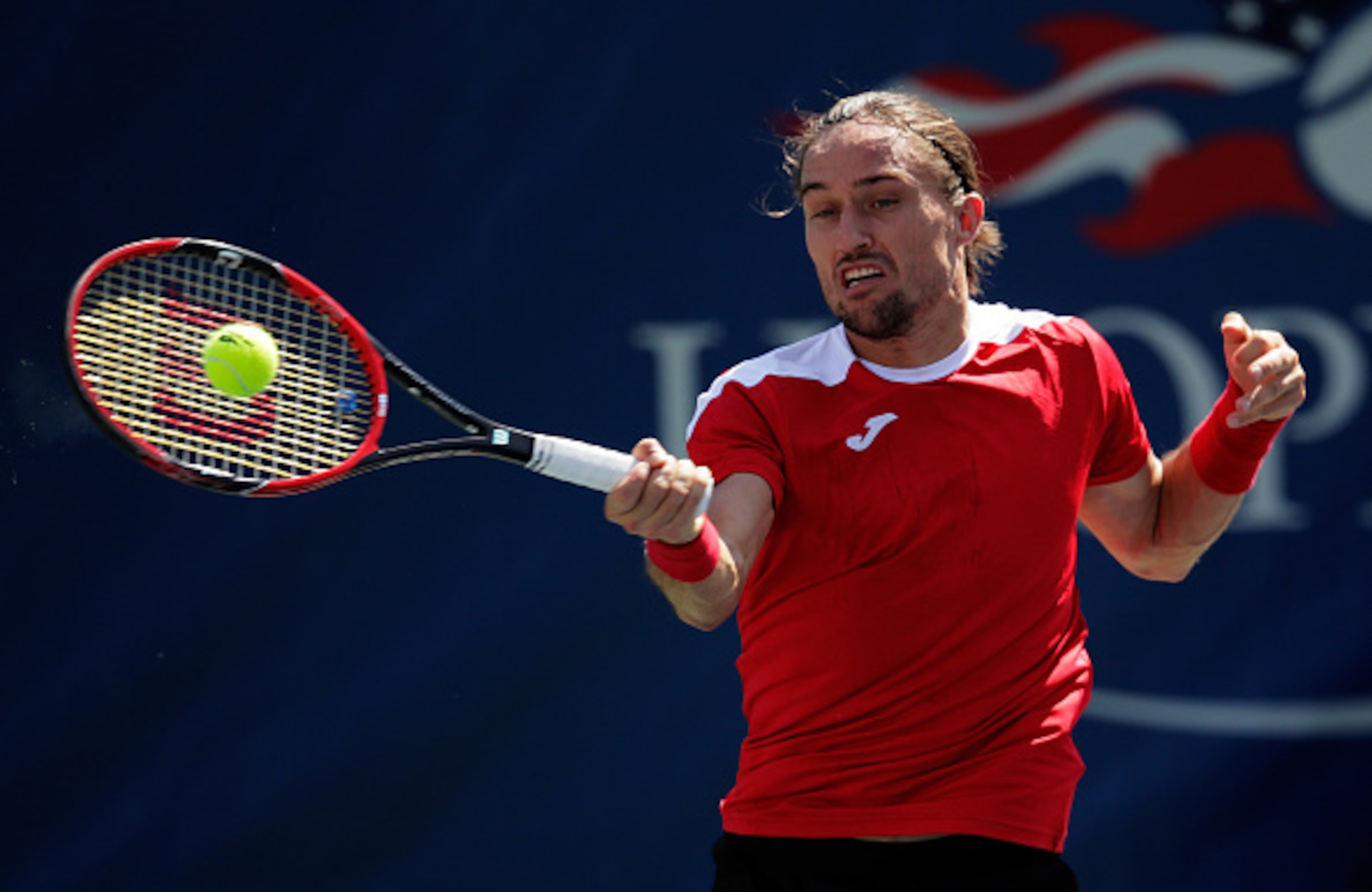 Alexandr Dolgopolov	hits a forehand during the 2016 U.S. Open.