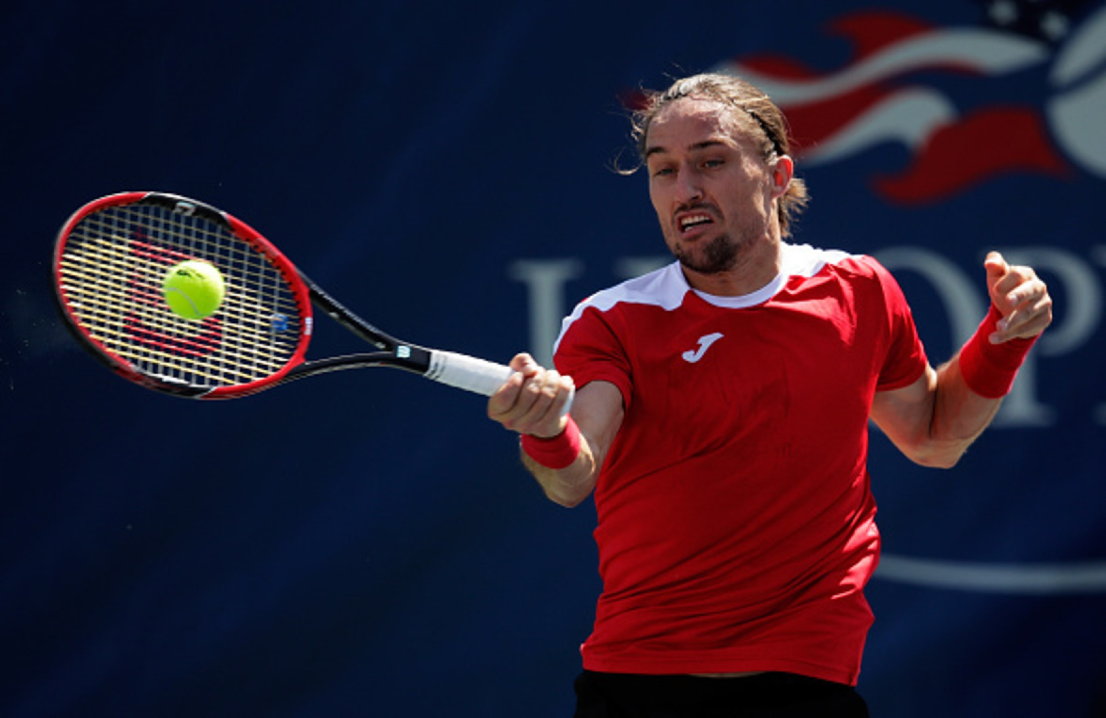 Alexandr Dolgopolov	hits a forehand during the 2016 U.S. Open.