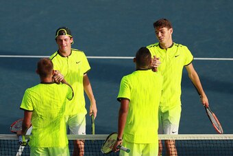 Men's doubles teams shake hands after a match at the 2016 U.S. Open.