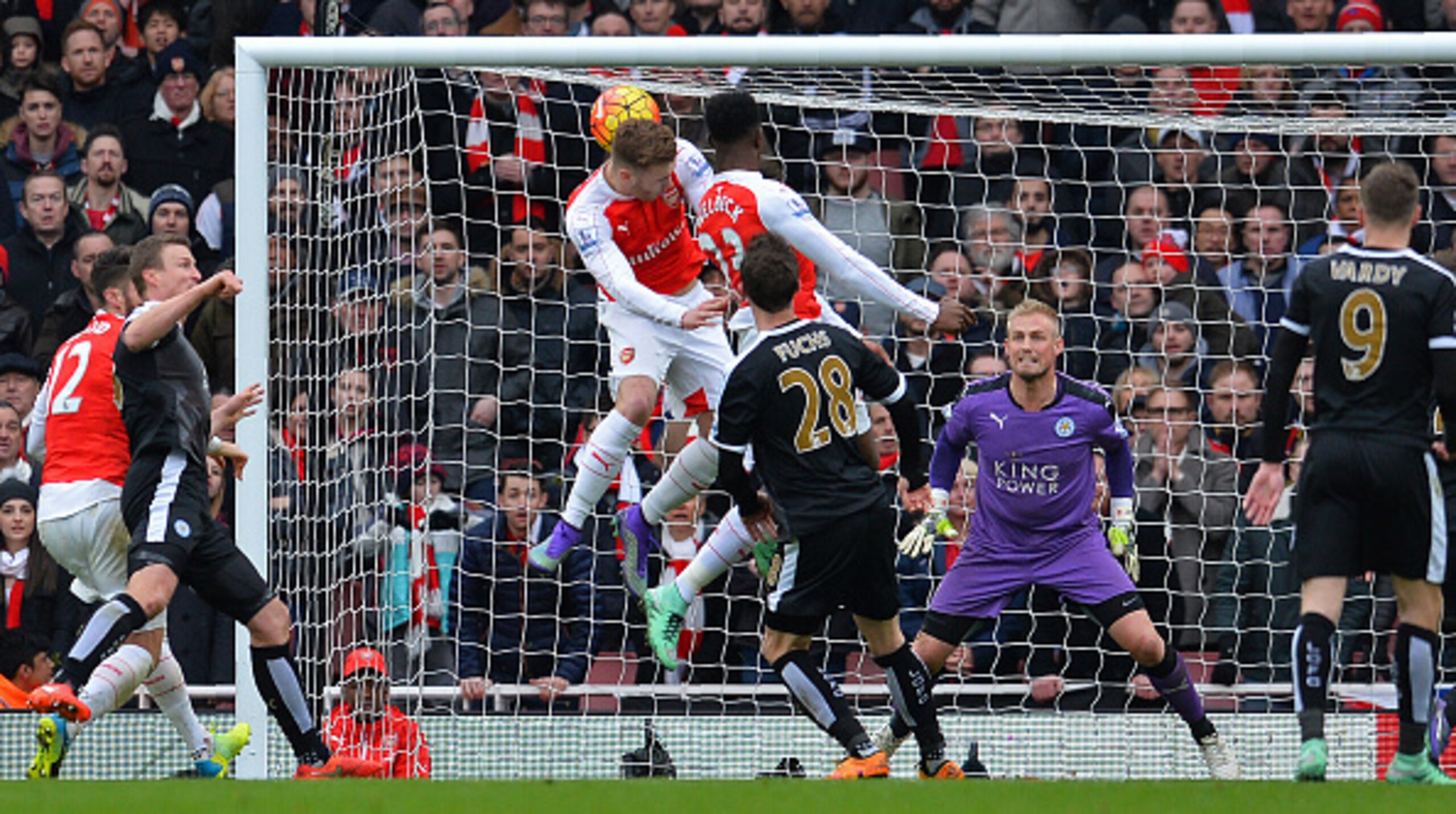 Danny Welbeck rises to flick home Arsenal's late winner.