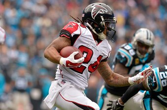 CHARLOTTE, NC - DECEMBER 24:  Devonta Freeman #24 of the Atlanta Falcons runs the ball against the Carolina Panthers in the 1st quarter during the game at Bank of America Stadium on December 24, 2016 in Charlotte, North Carolina.  (Photo by Grant Halverso