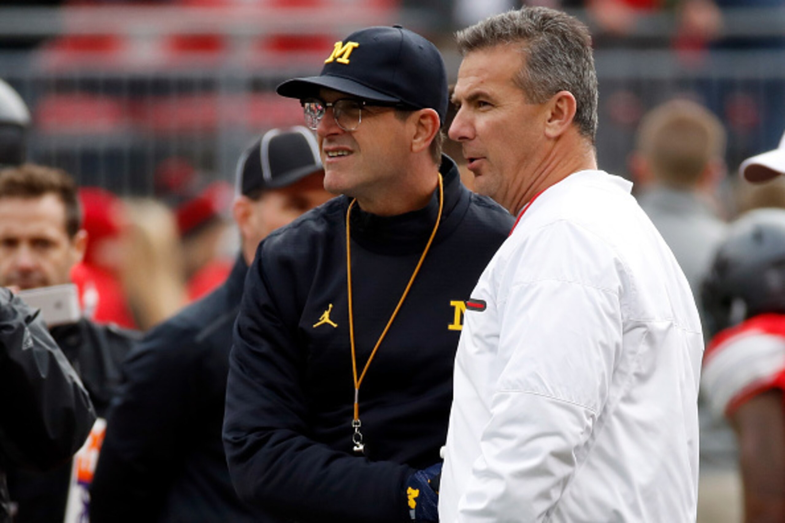 Michigan coach Jim Harbaugh, left, and Ohio State coach Urban Meyer have maintained their respective recruiting success.