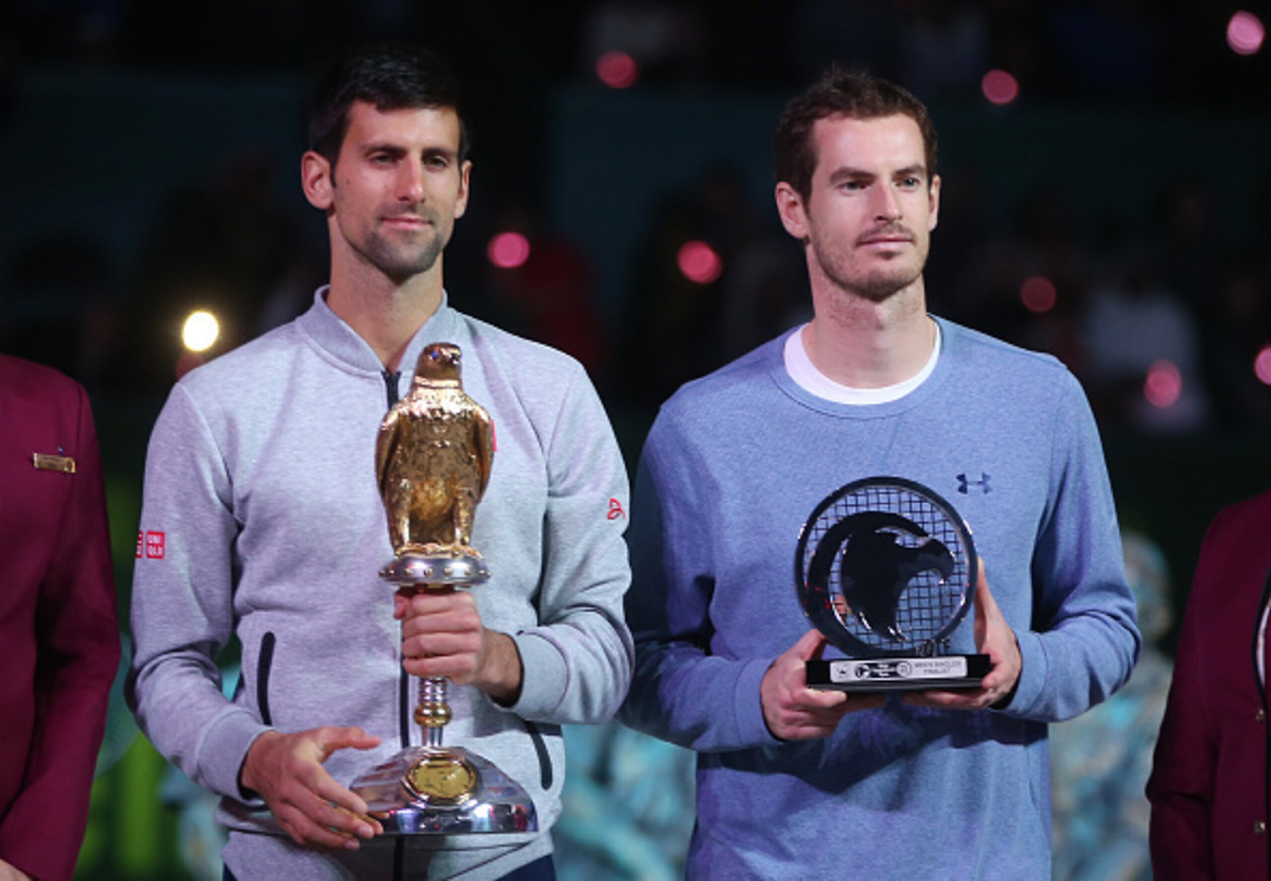 Djokovic and Murray hold their trophies in Doha.