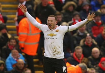 Rooney celebrates in front of unimpressed Liverpool fans.