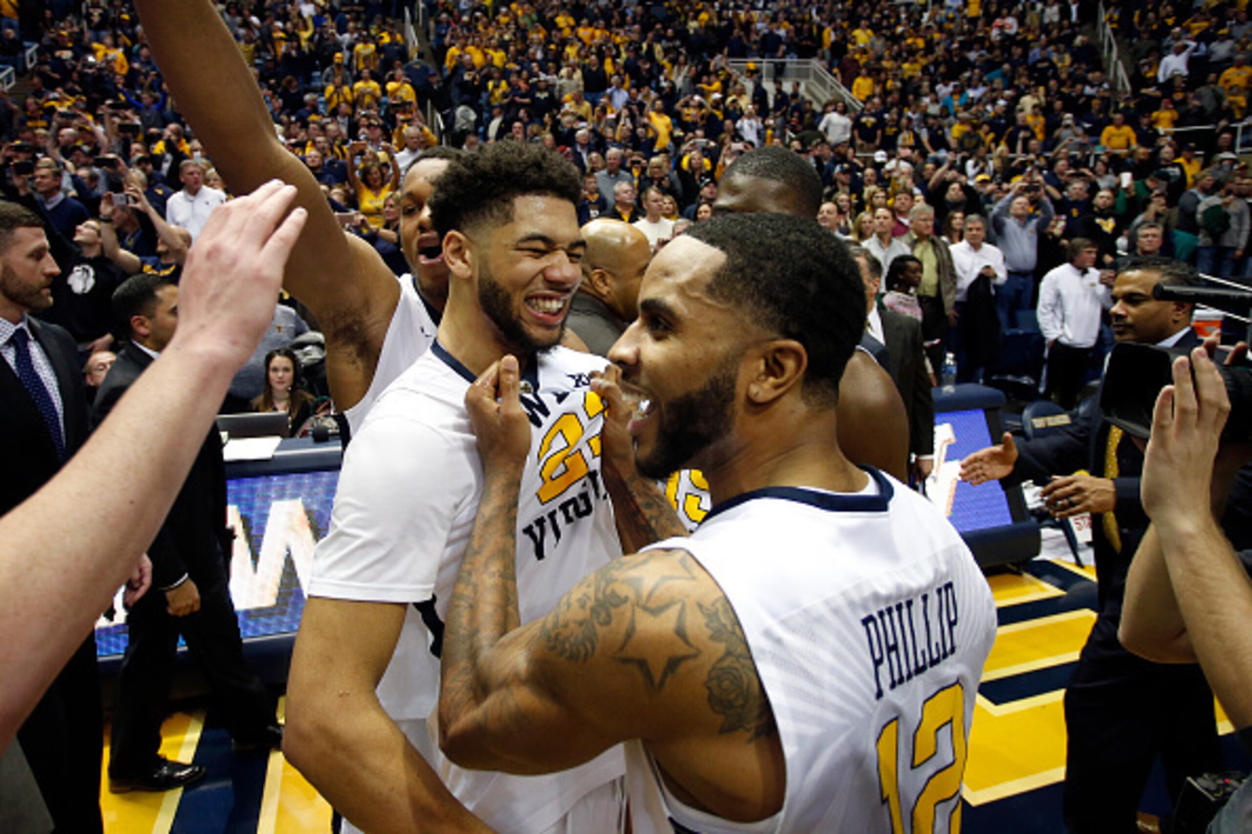 Tarik Phillip grabs Esa Ahmad after the Mountaineers upset Baylor.