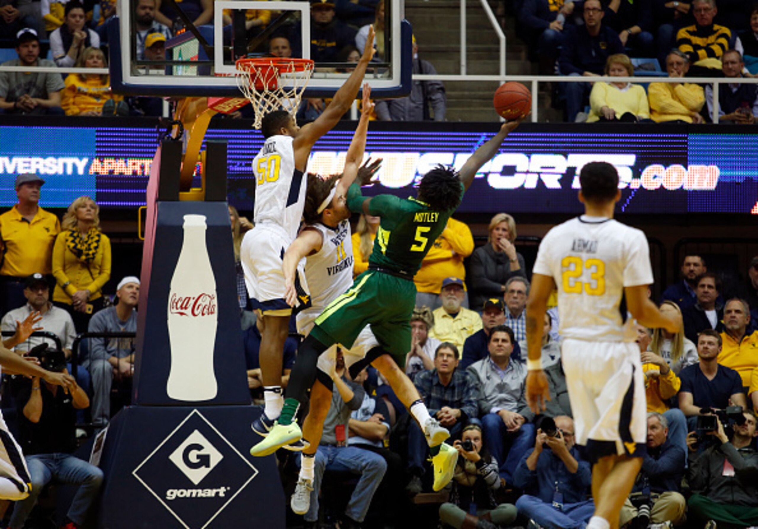 Johnathan Motley is mobbed by WVU defenders.
