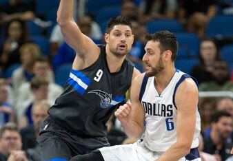 Magic C Nikola Vucevic (left) and Mavericks C Andrew Bogut