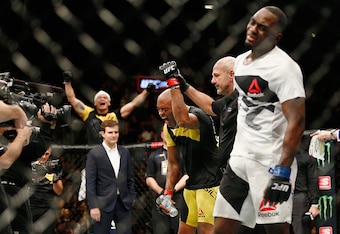 Anderson Silva (left) celebrates as Derek Brunson reacts.