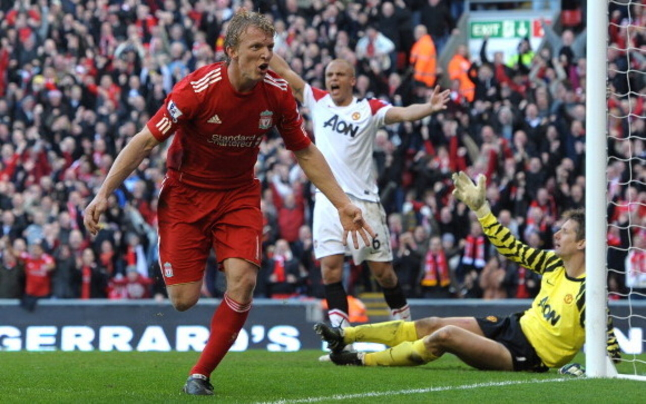 Dirk Kuyt wheels away to celebrate after scoring against Manchester United.