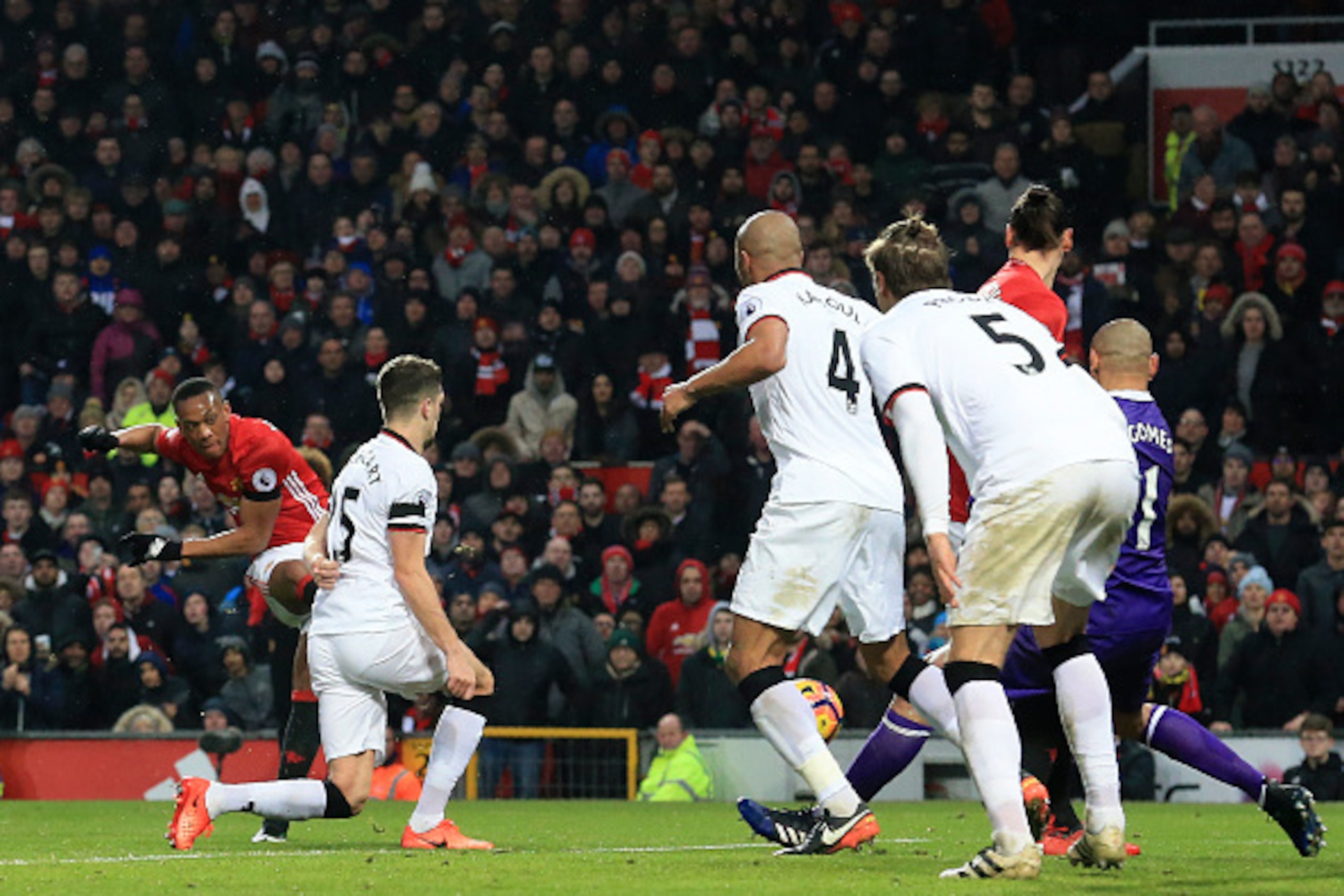 Watford defenders look on as Martial scores another goal for United.