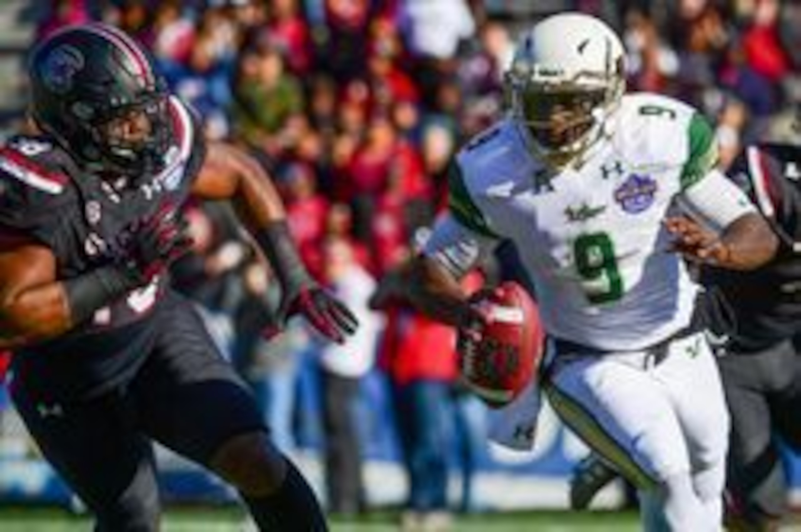 Dec 29, 2016; Birmingham, AL, USA; South Florida Bulls quarterback Quinton Flowers (9) runs the ball around South Carolina Gamecocks defensive lineman Stephon Taylor (98) during the first quarter in the 2016 Birmingham Bowl at Legion Field. Mandatory Cred