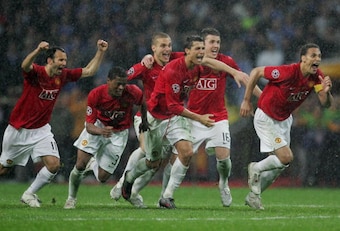 United players rush over towards Edwin van der Sar after he saves the vital penalty in Moscow.
