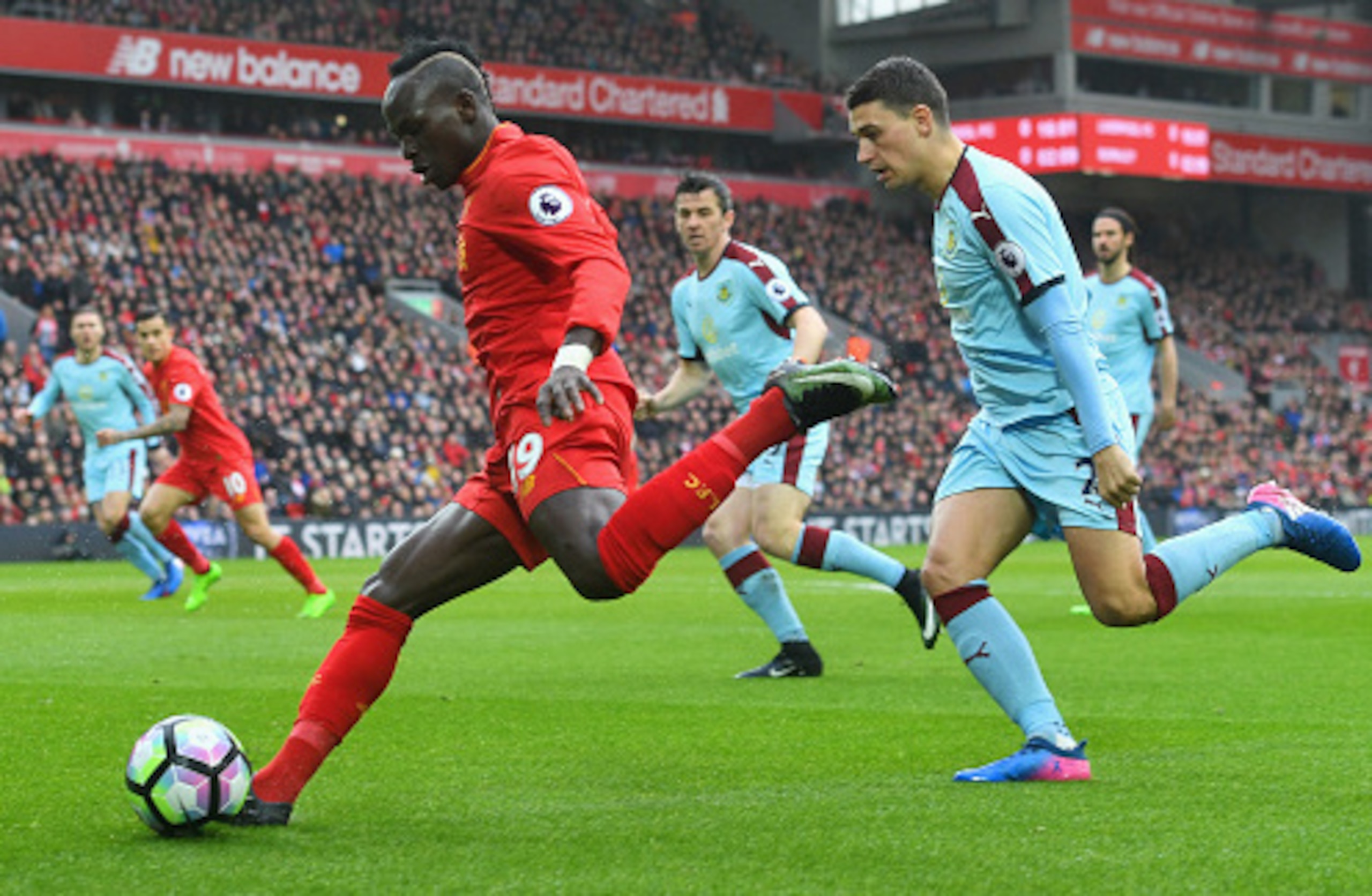 LIVERPOOL, ENGLAND - MARCH 12:  Sadio Mane of Liverpool evades Matthew Lowton of Burnley during the Premier League match between Liverpool and Burnley at Anfield on March 12, 2017 in Liverpool, England.  (Photo by Michael Regan/Getty Images)
