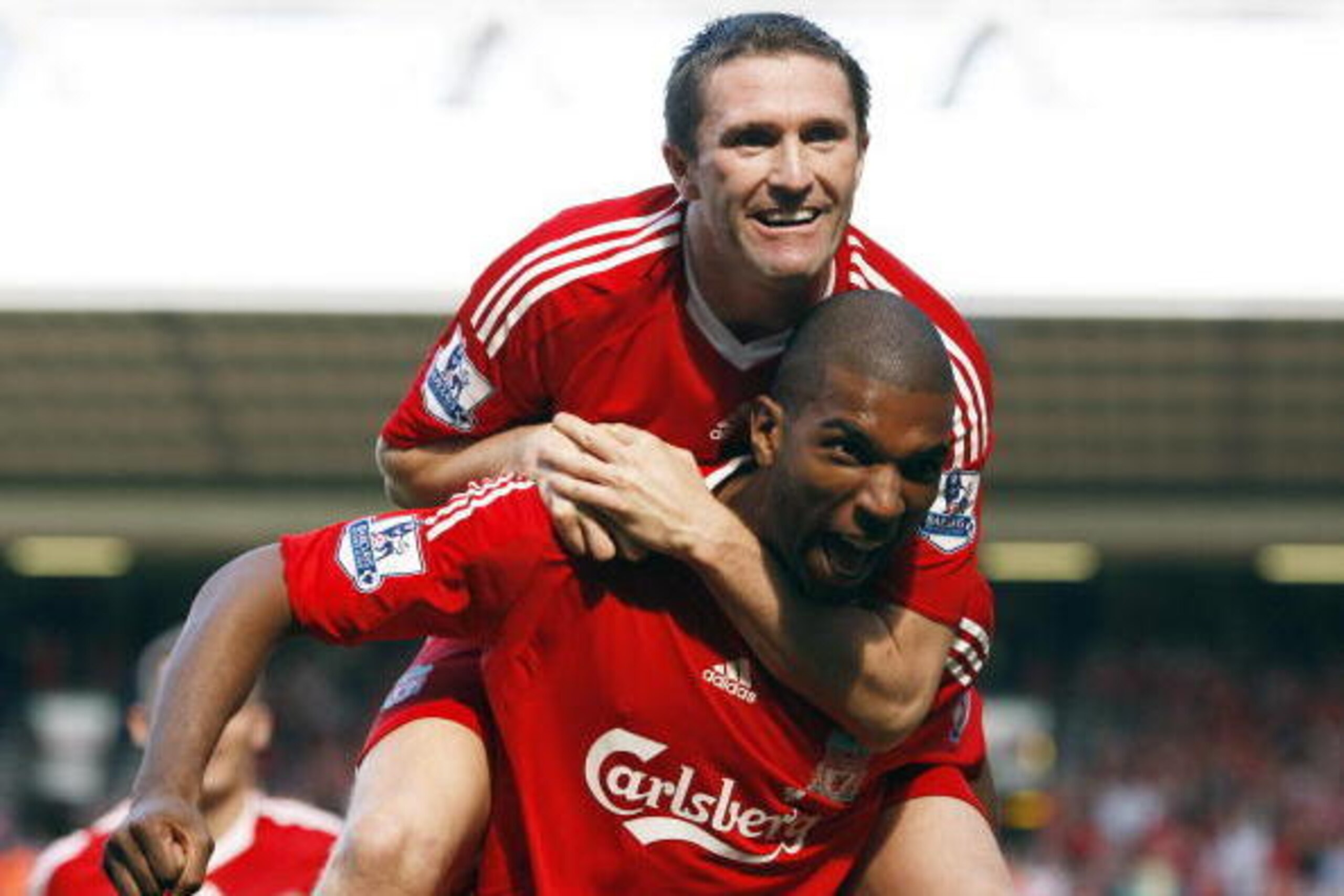 Robbie Keane celebrates a Liverpool goal with Ryan Babel in the 2008/09 season.