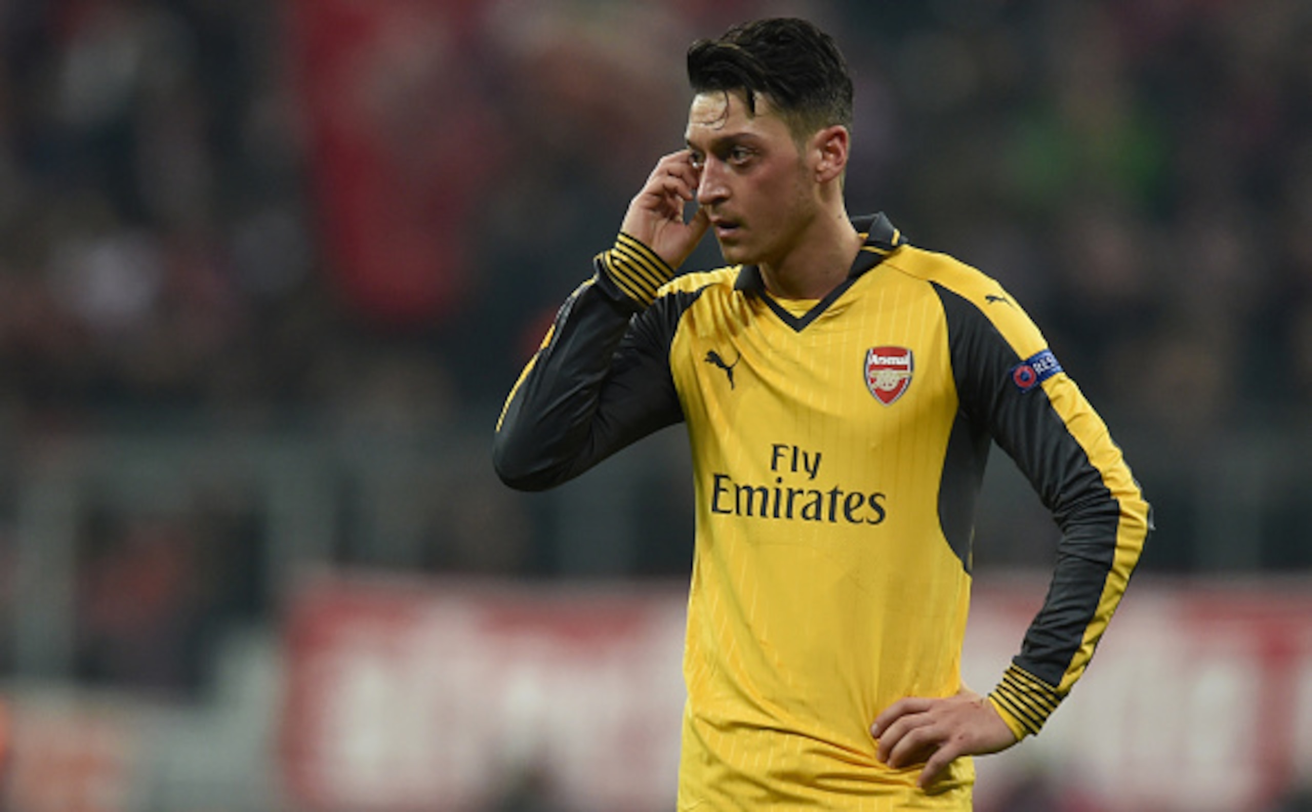 Arsenal's German midfielder Mesut Ozil reacts during the UEFA Champions League round of sixteen football match between FC Bayern Munich and Arsenal in Munich, southern Germany, on February 15, 2017.  / AFP / Christof STACHE        (Photo credit should rea
