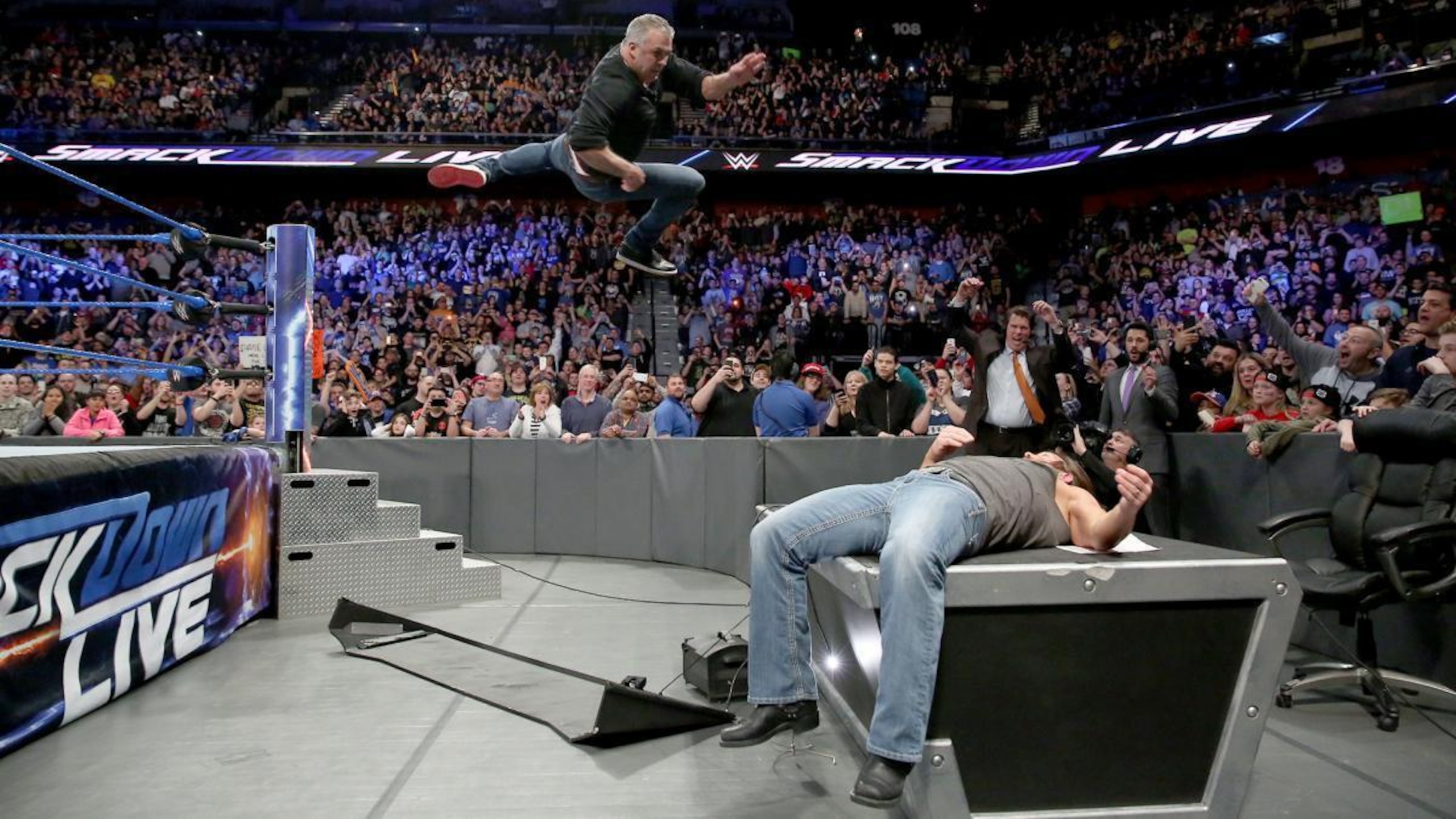 Shane McMahon drops the elbow on AJ Styles.