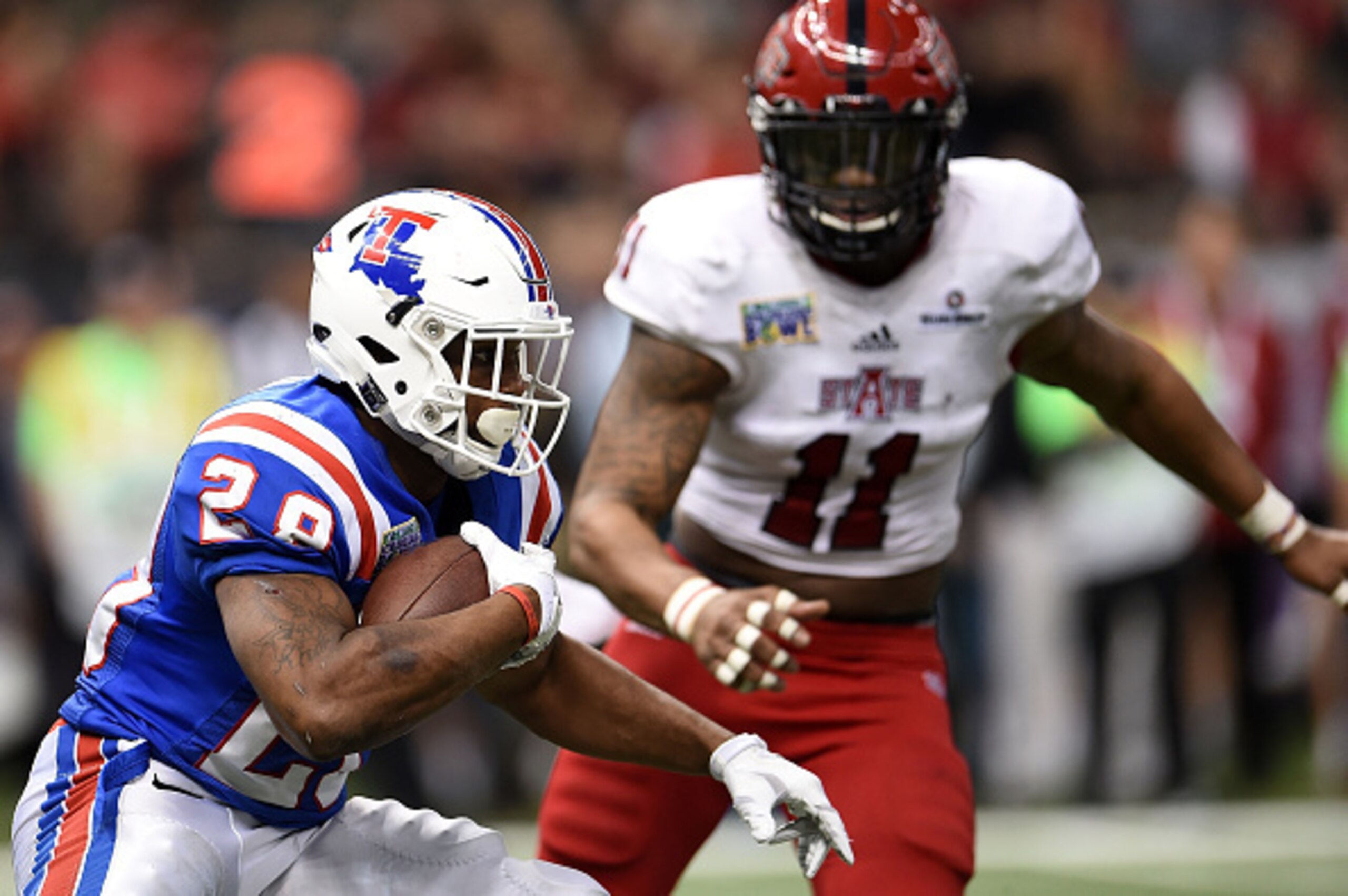 NEW ORLEANS, LA - DECEMBER 19: Kenneth Dixon #28 of the Louisiana Tech Bulldogs is pursued by Ja'Von Rolland-Jones #11 of the Arkansas State Red Wolves during the third quarter of the R+L Carriers New Orleans Bowl at the Mercedes-Benz Superdome on Decemb NEW ORLEANS, LA - DECEMBER 19: Kenneth Dixon #28 of the Louisiana Tech Bulldogs is pursued by Ja'Von Rolland-Jones #11 of the Arkansas State Red Wolves during the third quarter of the R+L Carriers New Orleans Bowl at the Mercedes-Benz Superdome on Decemb