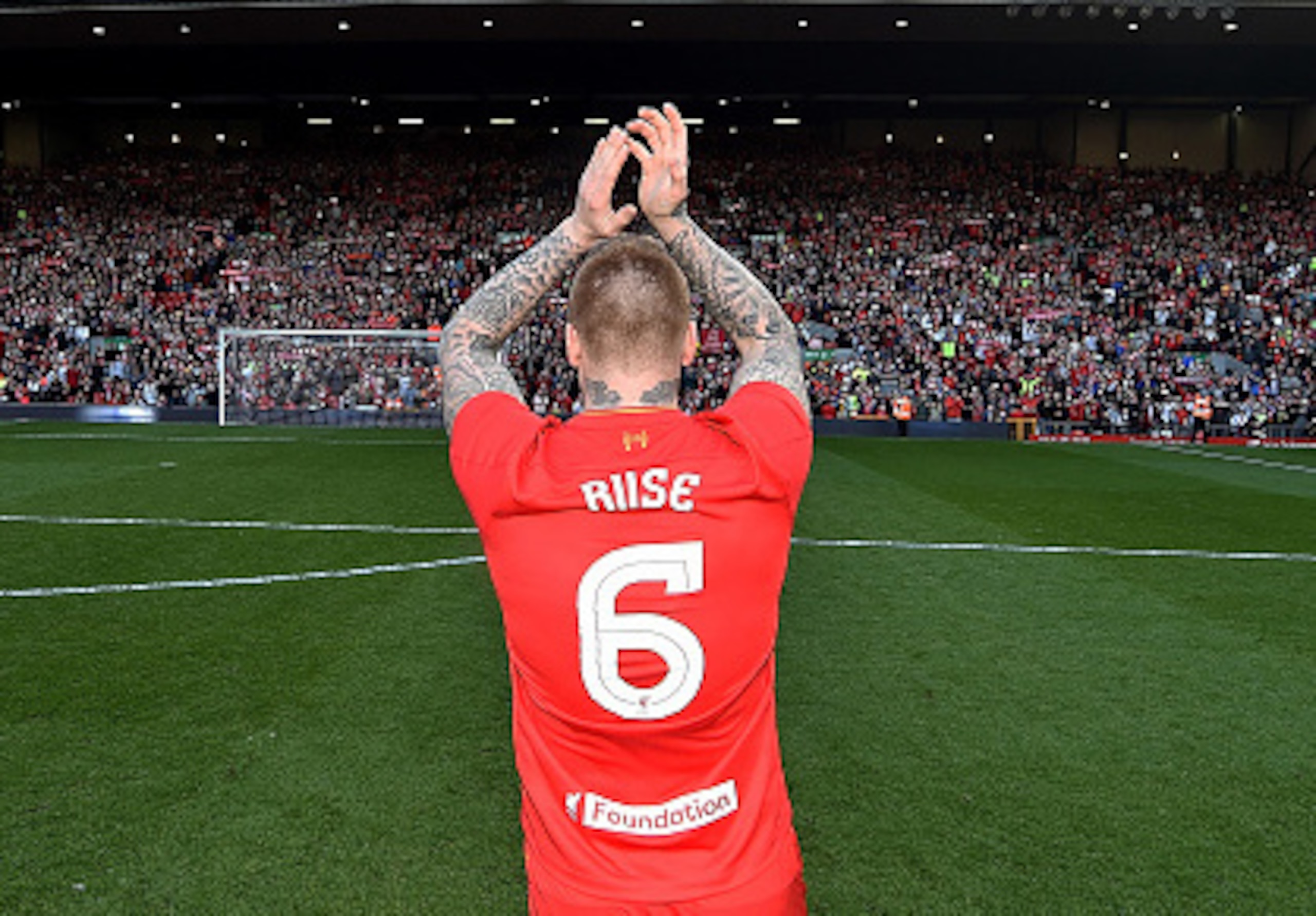 John Arne Riise salutes the Kop during a charity match at Anfield.