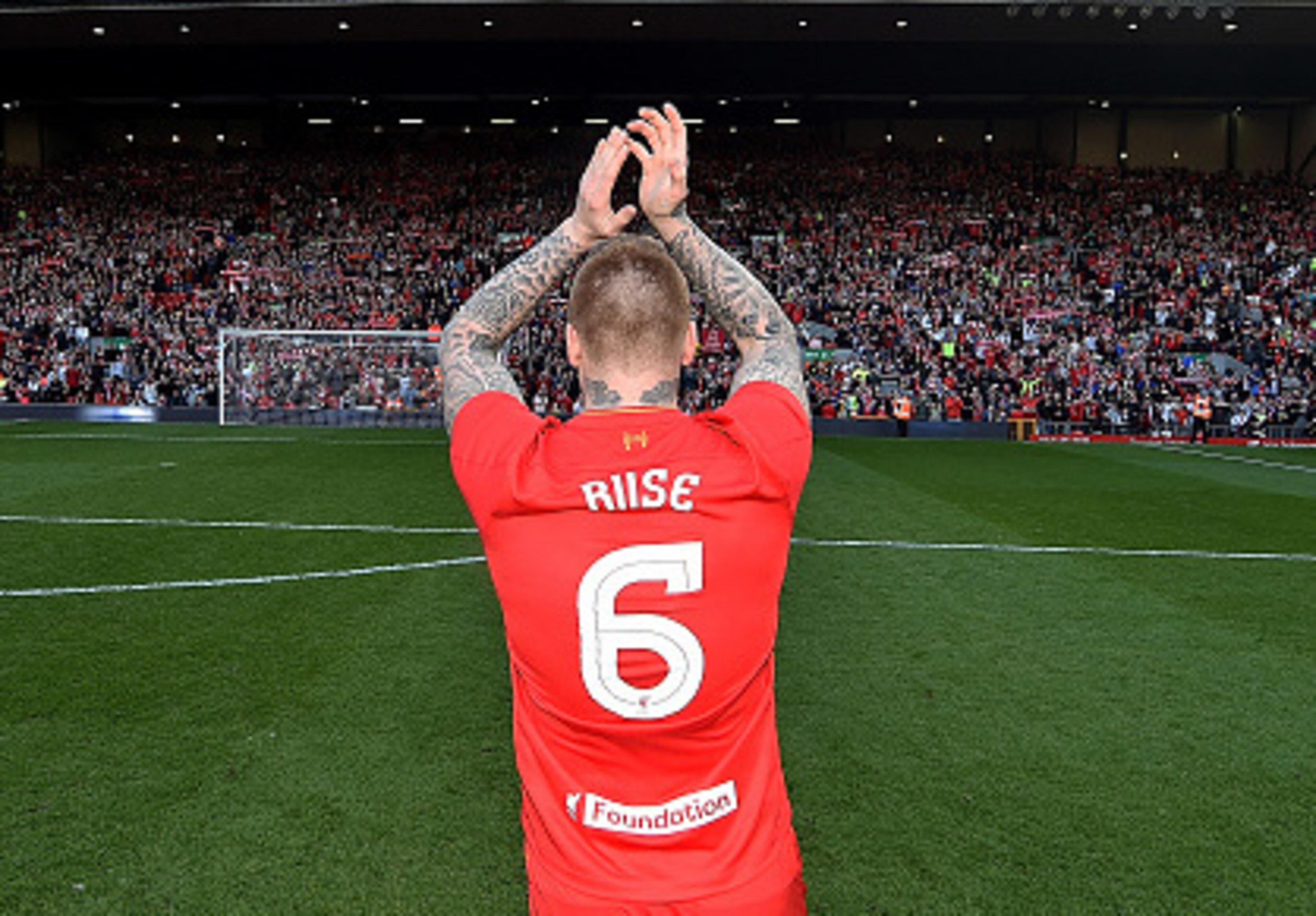 John Arne Riise salutes the Kop during a charity match at Anfield.