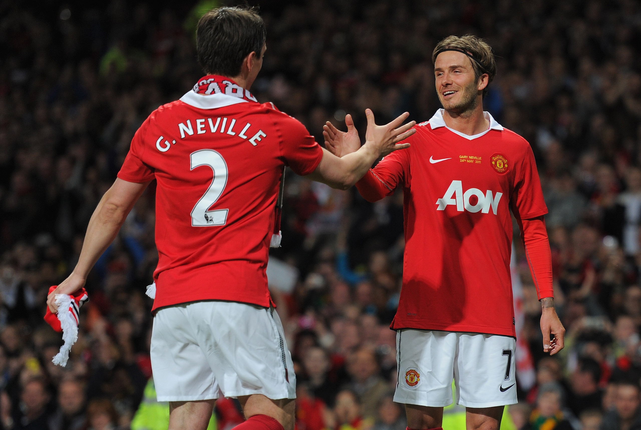 Gary Neville celebrates his testimonial with an old friend.