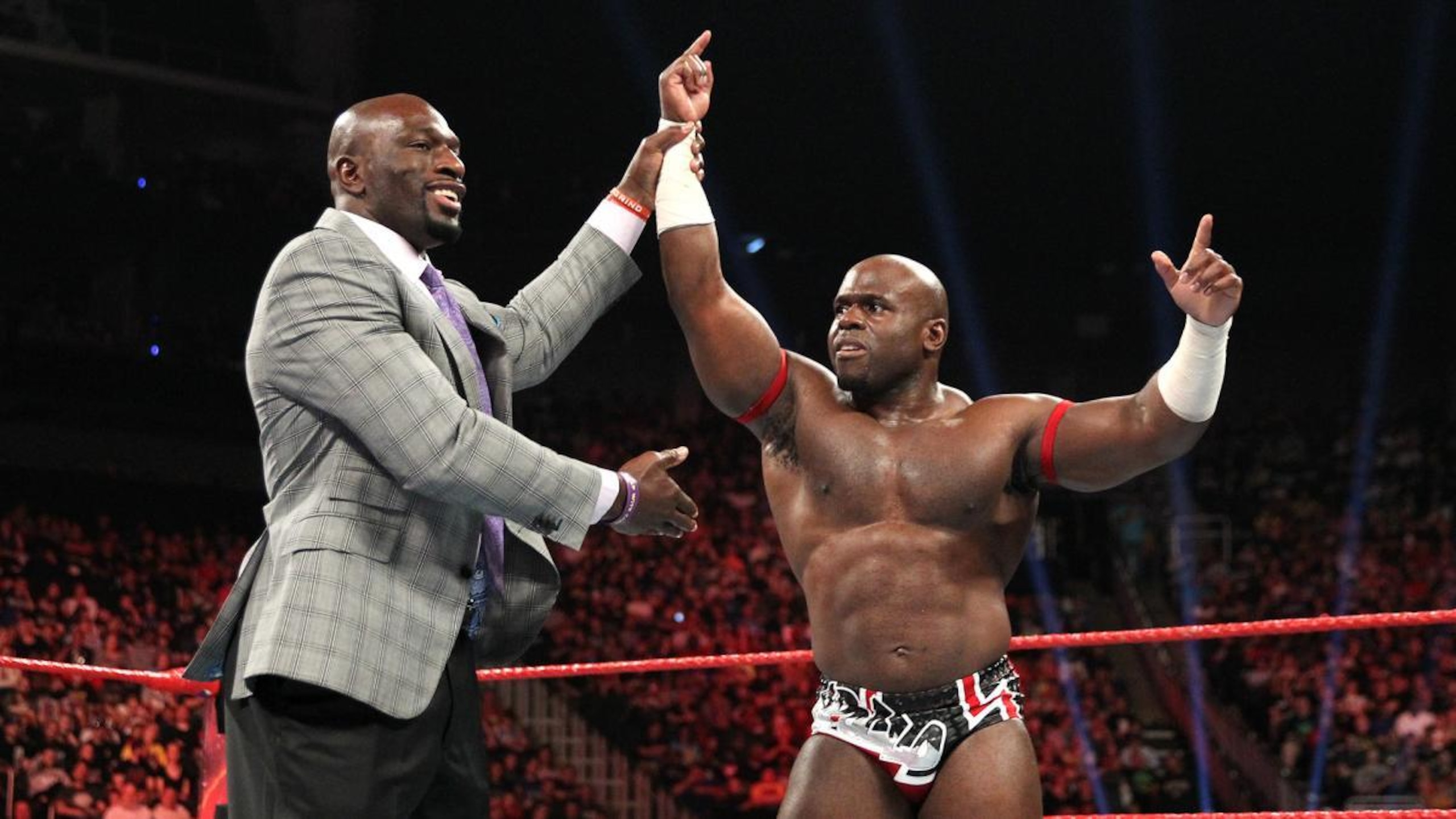 Titus O'Neil congratulates Apollo Crews. Titus O'Neil congratulates Apollo Crews.